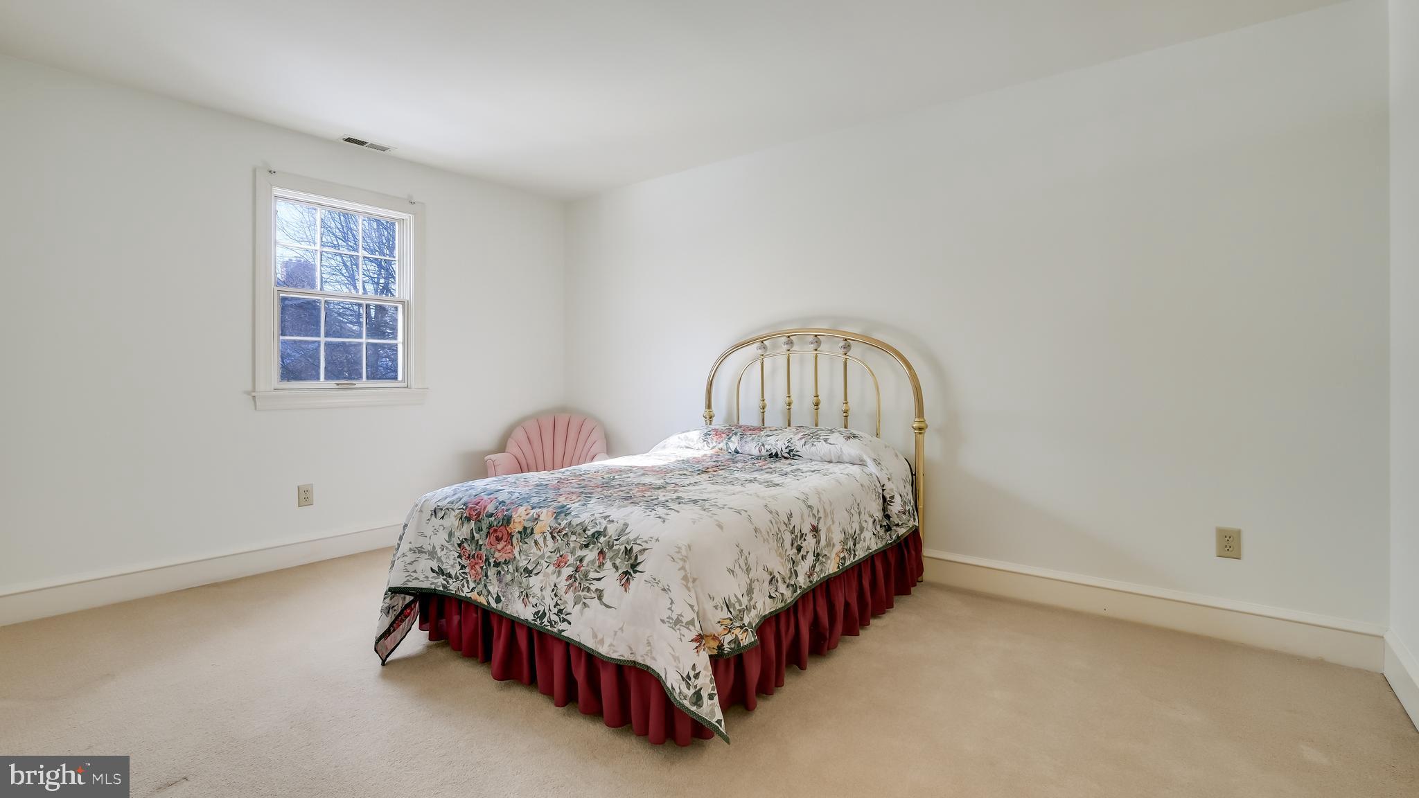 45 Latham Court Doylestown, PA 18901 - Photo 25 of 41 a spacious bedroom with a bed lamp and a window