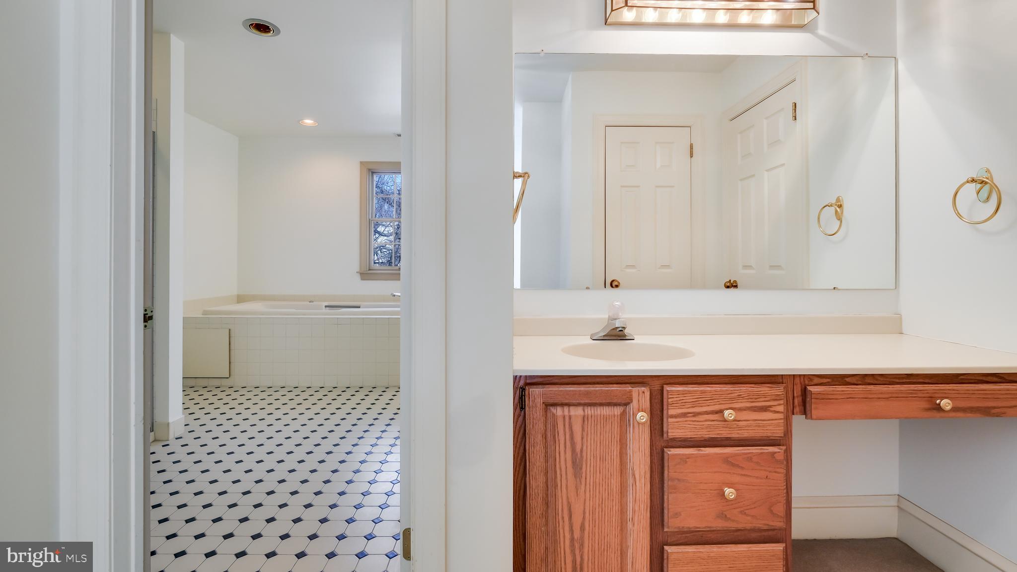 45 Latham Court Doylestown, PA 18901 - Photo 32 of 41 a bathroom with a sink a toilet and a mirror