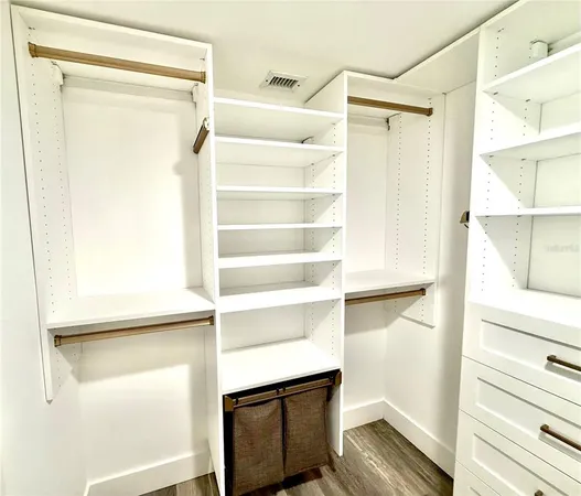 a view of walk in closet with empty racks