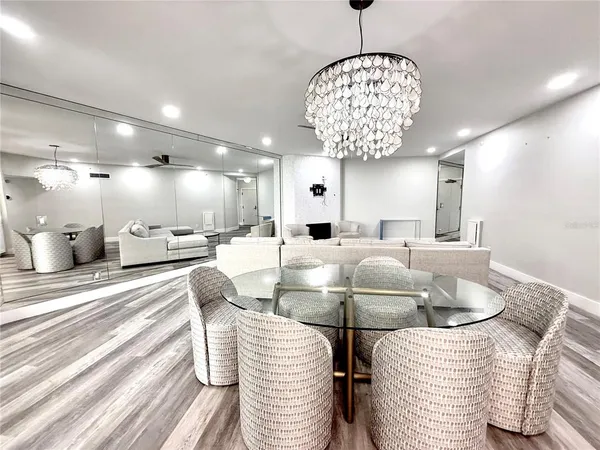 a dining room with furniture and a chandelier