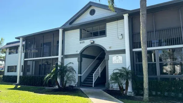 a front view of a house with yard and balcony