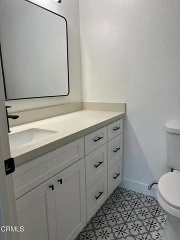 a bathroom with a toilet a sink and vanity