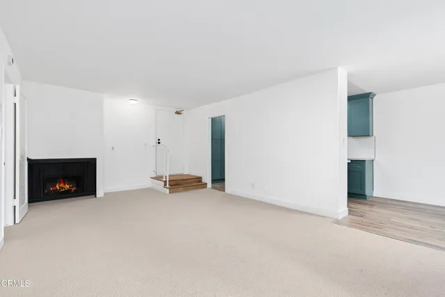 a view of an empty room with a fireplace