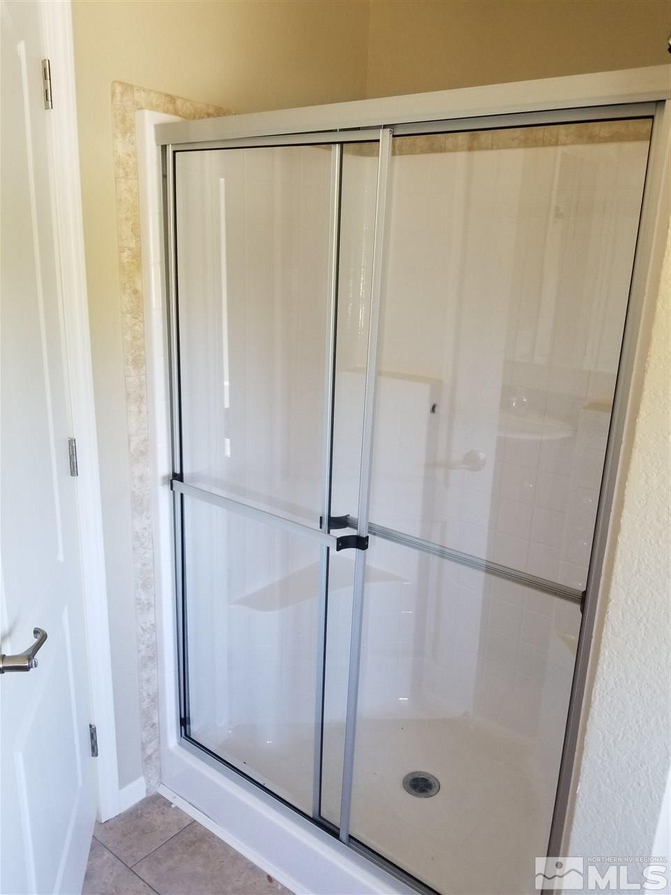 172 Hoge Road Reno, NV 89506 - Photo 15 of 17 a bathroom with a glass shower door