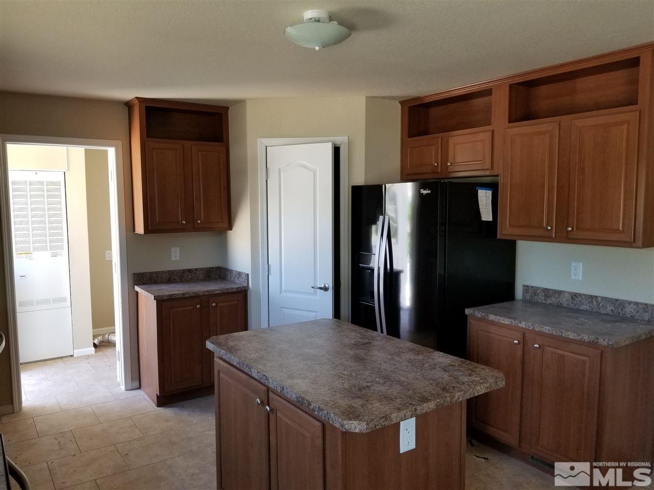 172 Hoge Road Reno, NV 89506 - Photo 16 of 17 a kitchen with stainless steel appliances granite countertop a refrigerator a sink and a stove