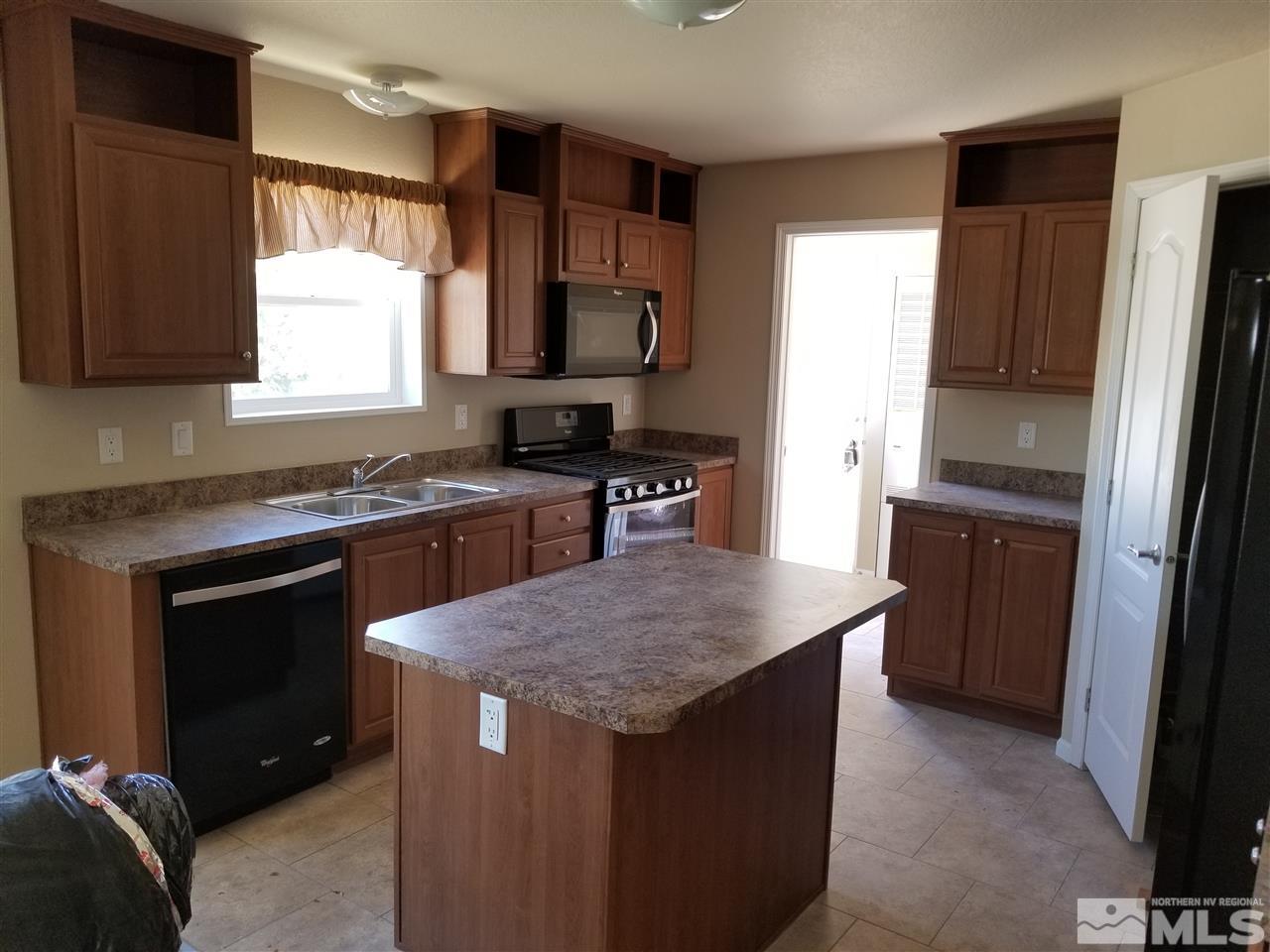 172 Hoge Road Reno, NV 89506 - Photo 17 of 17 a kitchen with stainless steel appliances granite countertop a stove a sink and a refrigerator