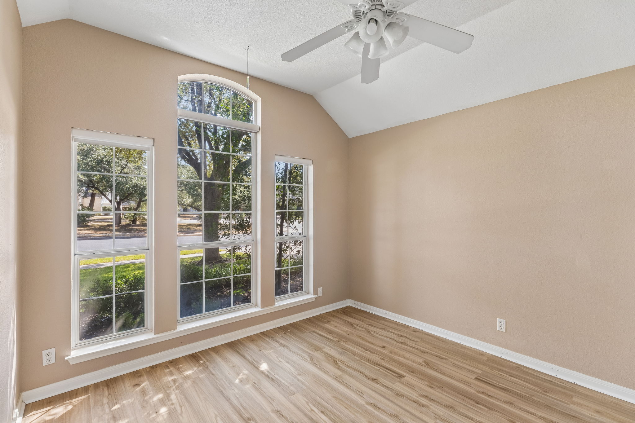 15814 Rustic Lane Austin, TX 78717 - Photo 5 of 29 Vaulted ceilings and handsome wood flooring define this versatile interior space filled with natural light.