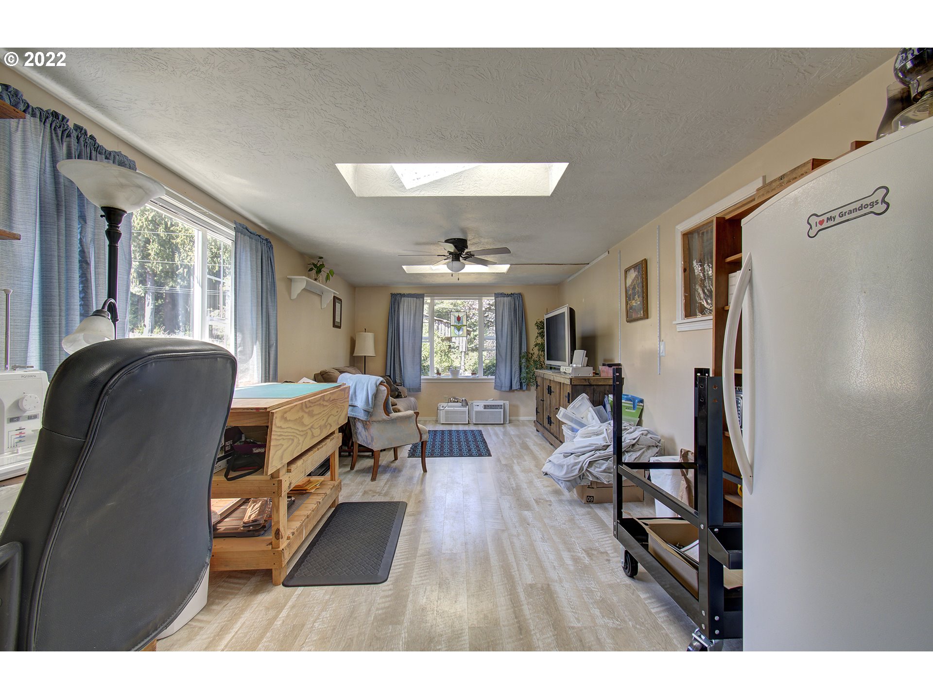 24402 Cox Road Rainier, OR 97048 - Photo 12 of 32 a living room with furniture a flat screen tv and a refrigerator