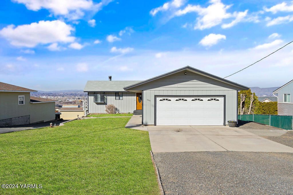 1005 Meadowbrook Road Yakima, WA 98903 - Photo 6 of 39 a view of a house with a yard and garage