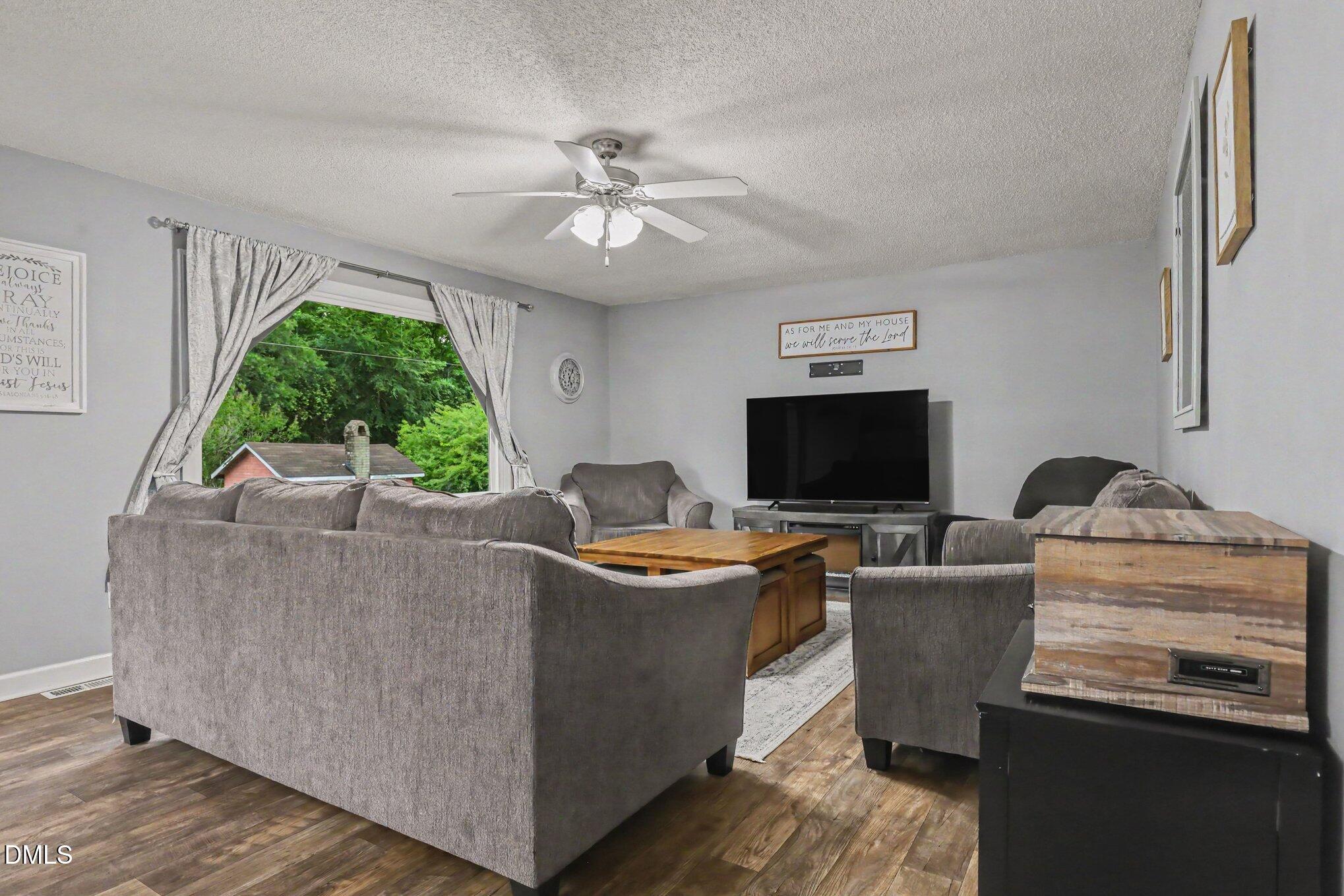 977 Stevens Mill Road Goldsboro, NC 27530 - Photo 8 of 31 a living room with furniture and a flat screen tv