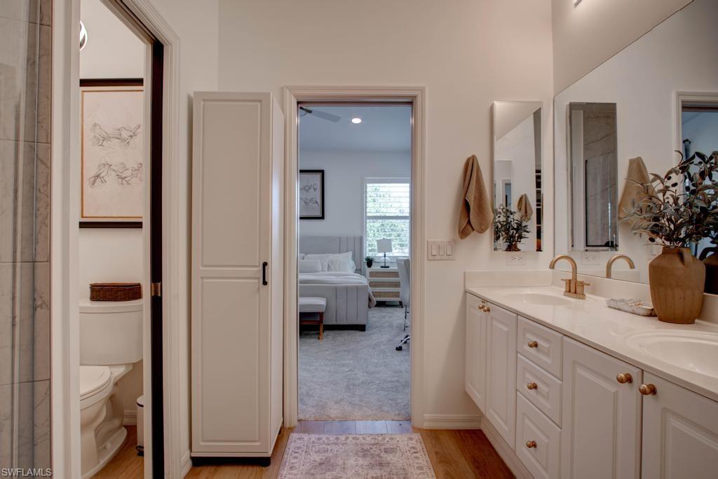 1969 Crestview Way, Unit 152 Naples, FL 34119 - Photo 17 of 35 a spacious en suite bathroom with a double vanity sink and a mirror