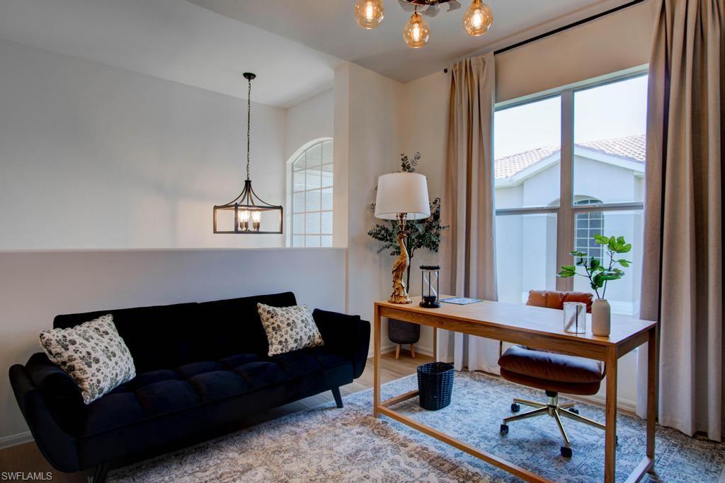 1969 Crestview Way, Unit 152 Naples, FL 34119 - Photo 18 of 35 a living room with furniture and a large window