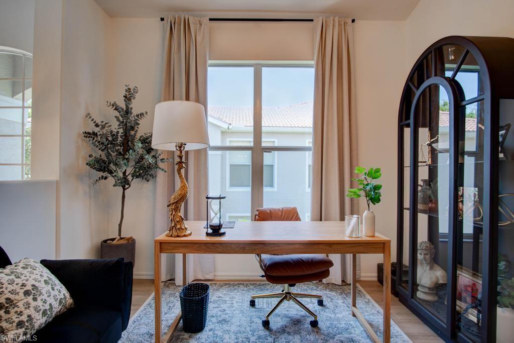 1969 Crestview Way, Unit 152 Naples, FL 34119 - Photo 20 of 35 a living room with furniture and a potted plant