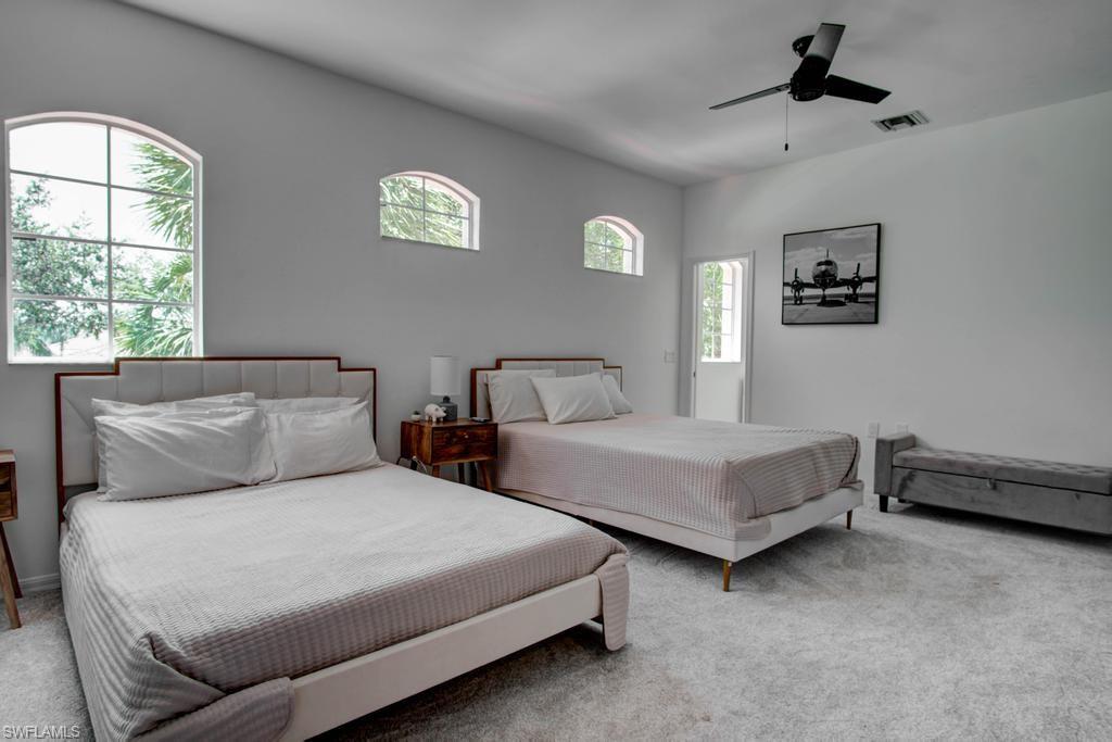 1969 Crestview Way, Unit 152 Naples, FL 34119 - Photo 21 of 35 a bedroom with two beds and a window