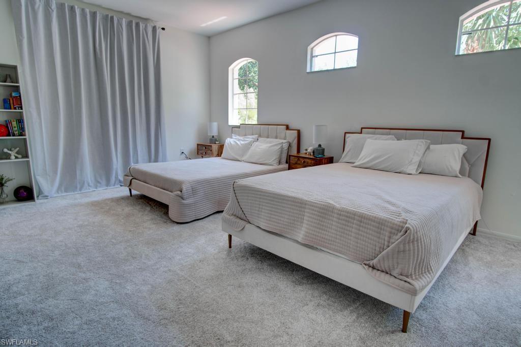 1969 Crestview Way, Unit 152 Naples, FL 34119 - Photo 22 of 35 a spacious bedroom with two beds and a window