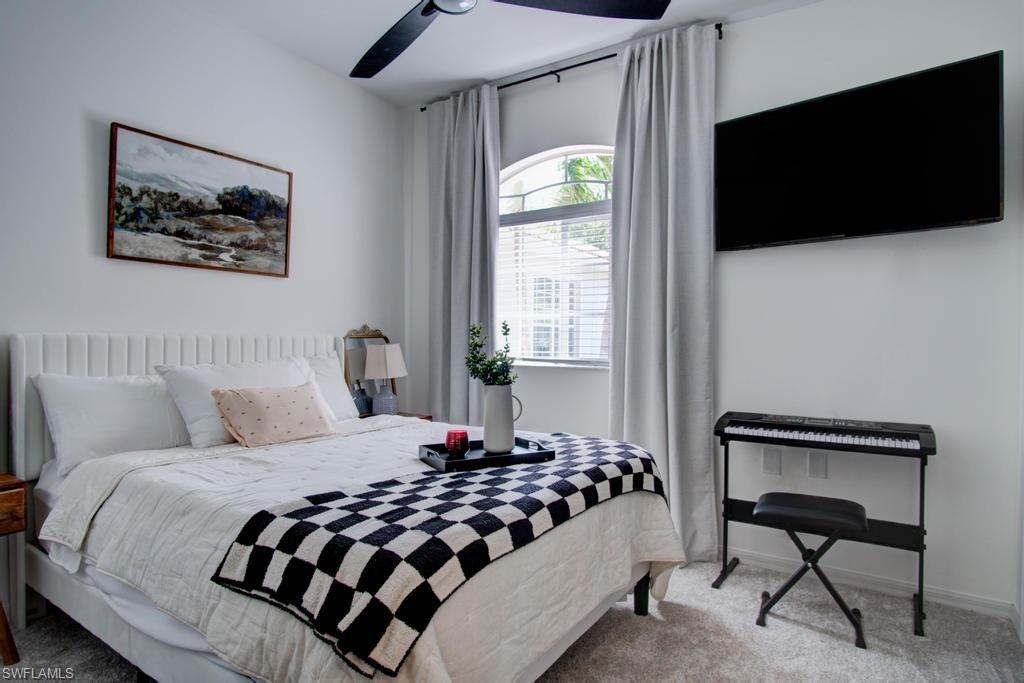 1969 Crestview Way, Unit 152 Naples, FL 34119 - Photo 24 of 35 a bedroom with a bed a flat screen tv and a window