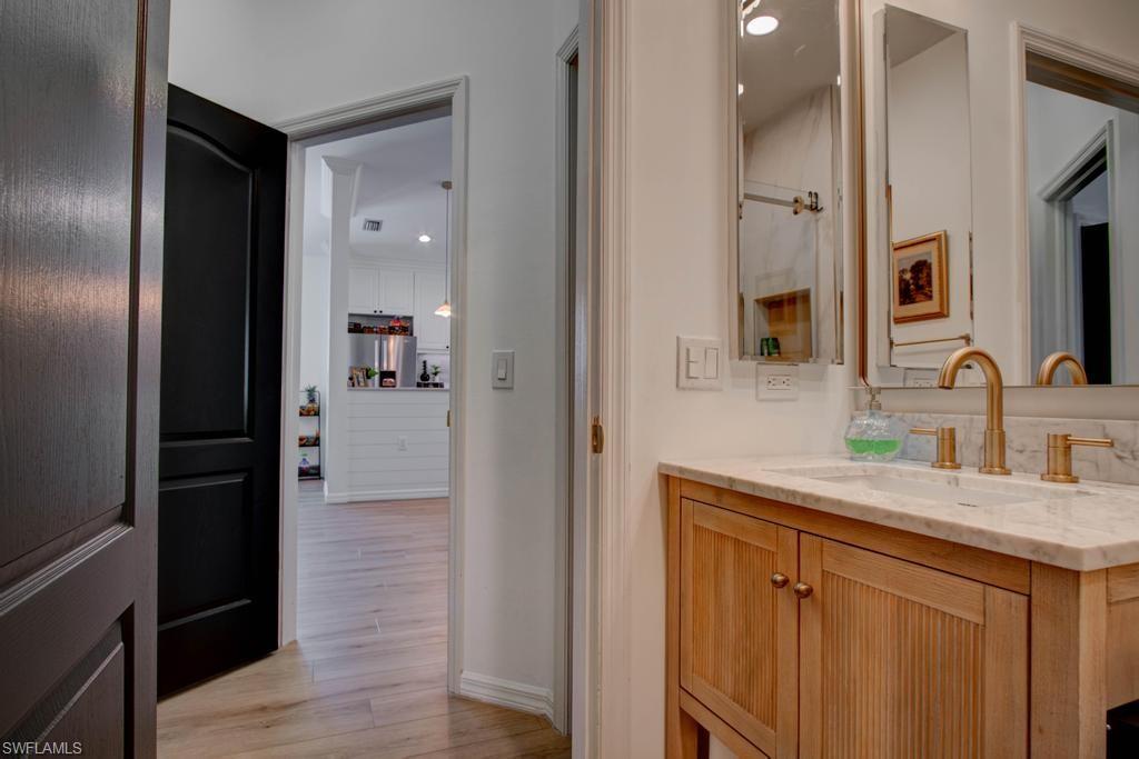 1969 Crestview Way, Unit 152 Naples, FL 34119 - Photo 26 of 35 a bathroom with a sink and a mirror