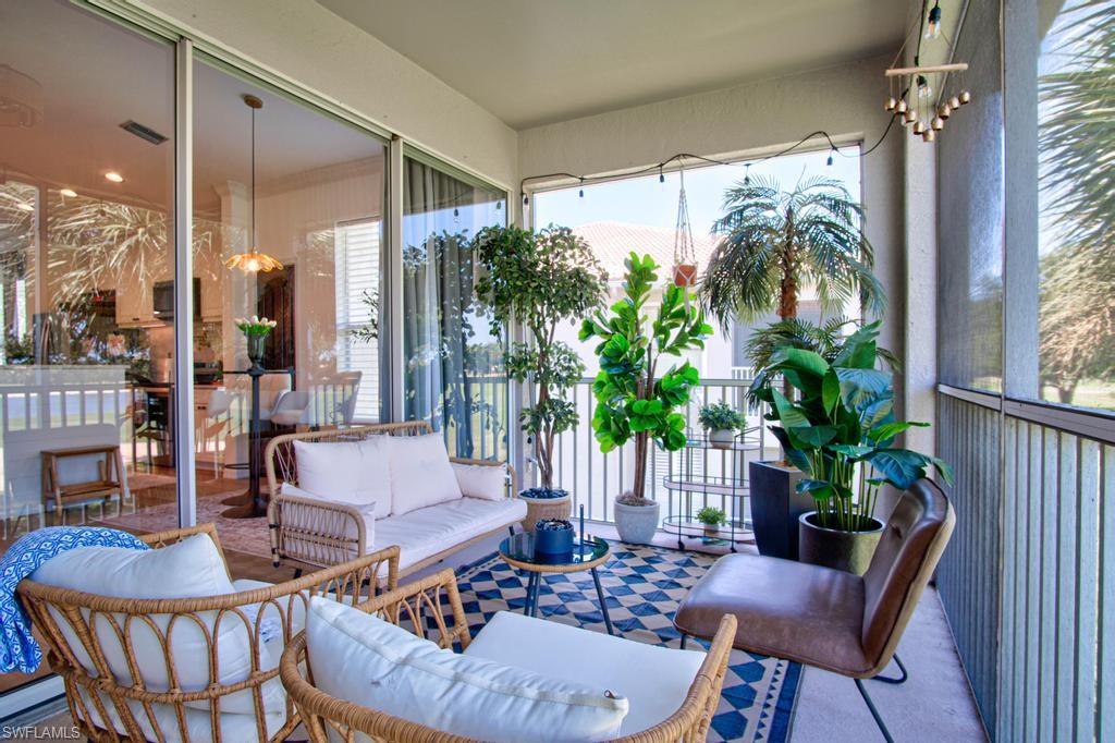 1969 Crestview Way, Unit 152 Naples, FL 34119 - Photo 29 of 35 a living room with furniture and a large window