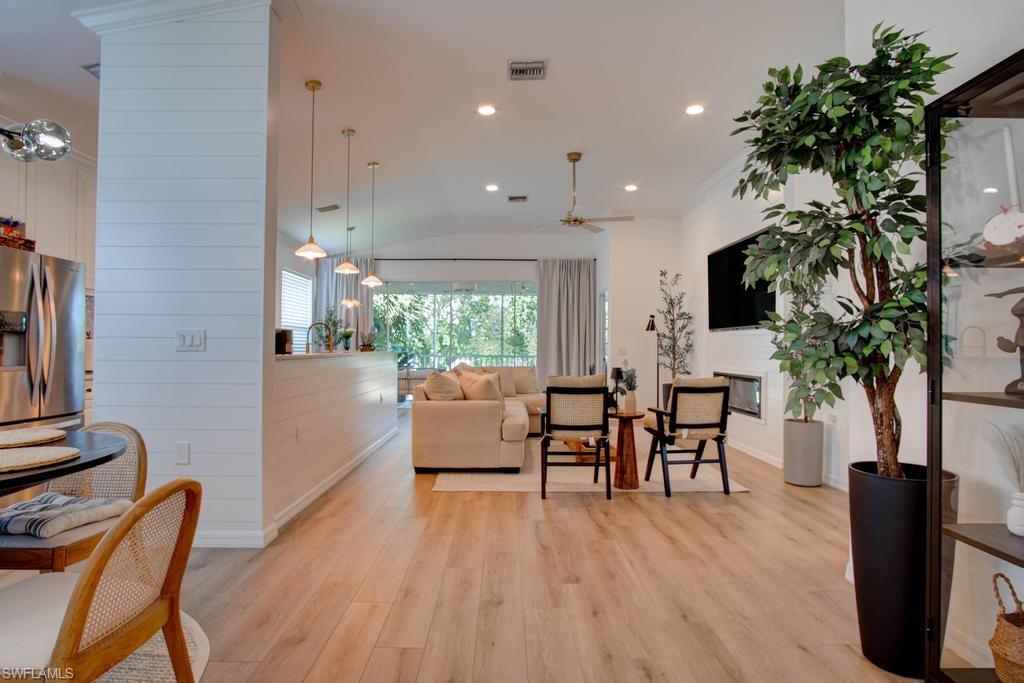1969 Crestview Way, Unit 152 Naples, FL 34119 - Photo 3 of 35 a living room with furniture a potted plant and a table
