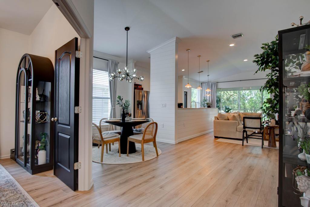 1969 Crestview Way, Unit 152 Naples, FL 34119 - Photo 31 of 35 a view of a dining room with furniture window and wooden floor