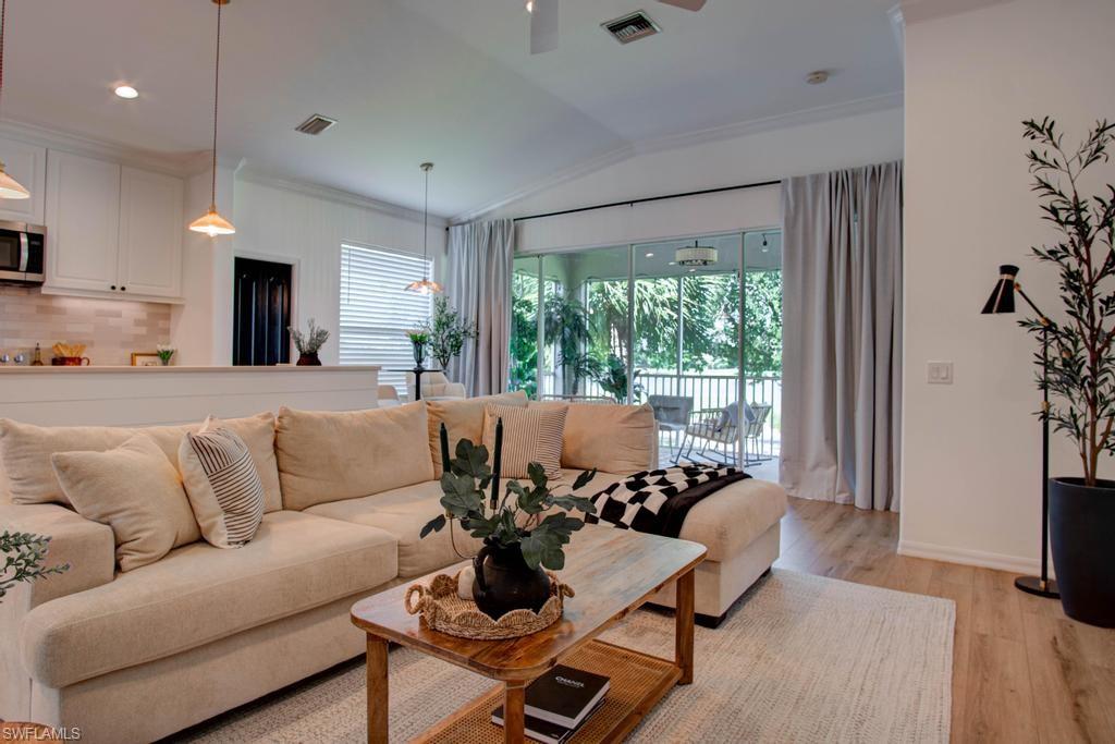 1969 Crestview Way, Unit 152 Naples, FL 34119 - Photo 4 of 35 a living room with furniture and a large window