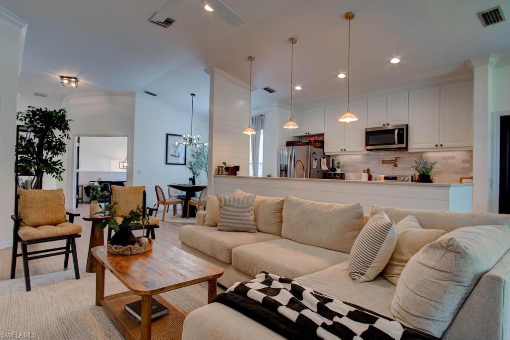 1969 Crestview Way, Unit 152 Naples, FL 34119 - Photo 7 of 35 a living room with furniture kitchen view and a flat screen tv