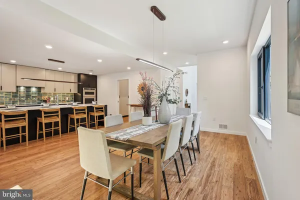 a view of a dining room with furniture and wooden floor