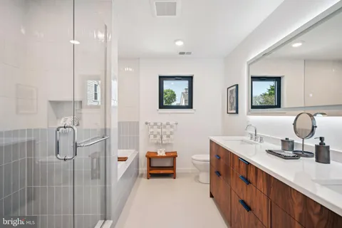 a en suite bathroom with a double vanity sink a mirror and a shower