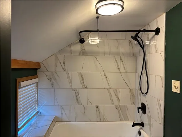 a bathroom with a shower and a bathtub