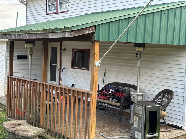 a view of a house with a wooden fence