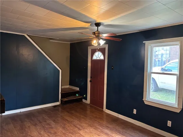 a view of entryway and hall with wooden floor