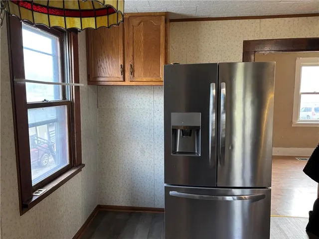 a metallic refrigerator freezer sitting in a kitchen