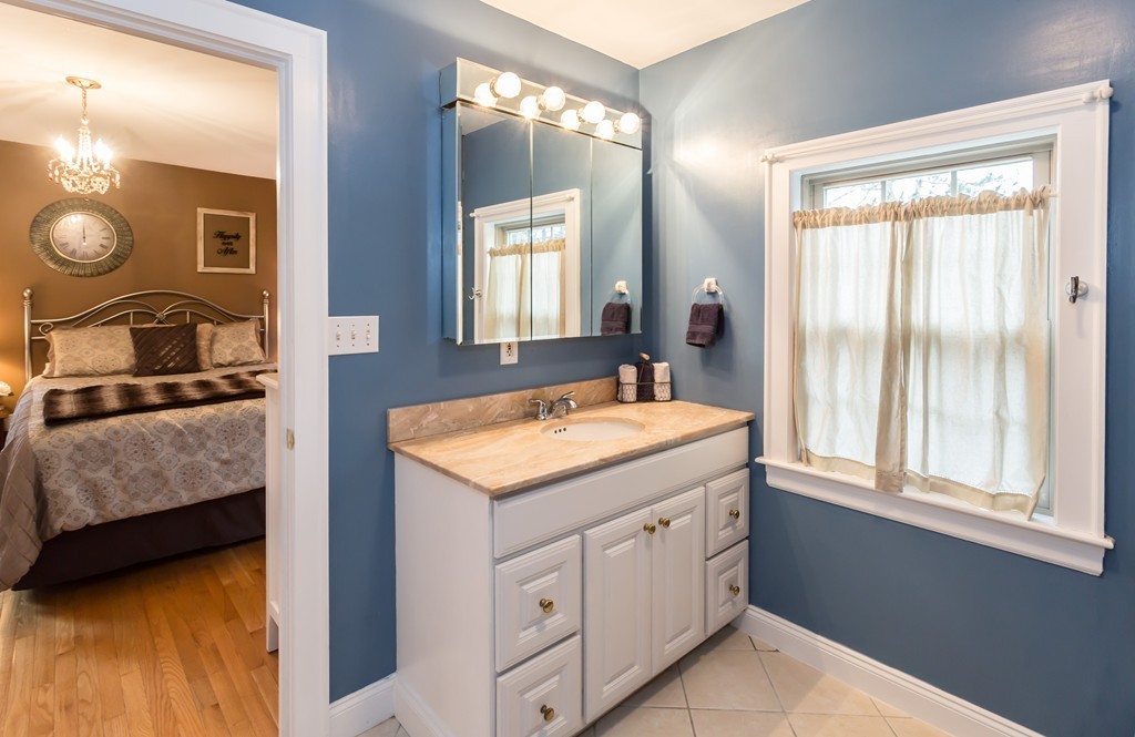 23 Mayflower Road Needham, MA 02492 - Photo 14 of 17 a bathroom with a granite countertop sink and a mirror