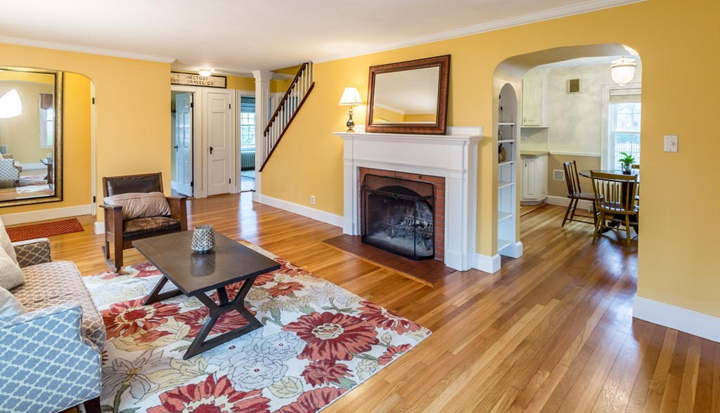 23 Mayflower Road Needham, MA 02492 - Photo 2 of 17 a living room with furniture and a fireplace