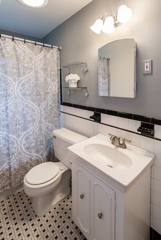 23 Mayflower Road Needham, MA 02492 - Photo 8 of 17 a bathroom with a sink a toilet and mirror