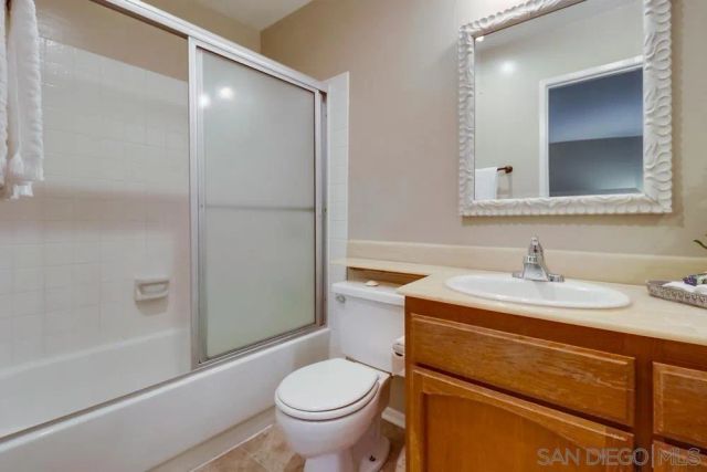 a bathroom with a sink toilet vanity and shower
