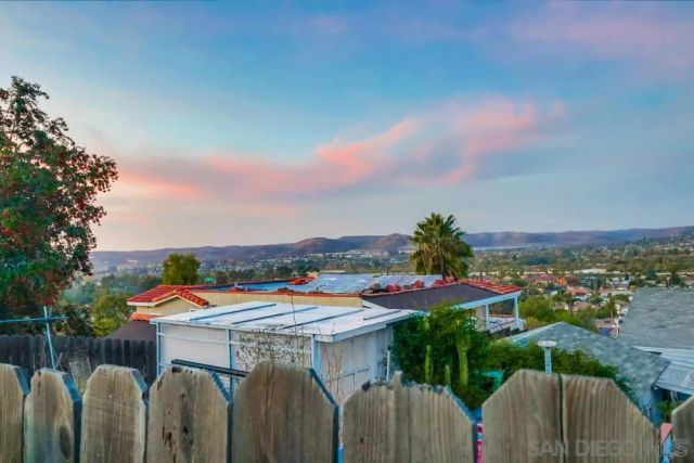 a view of a patio with furniture and a garden