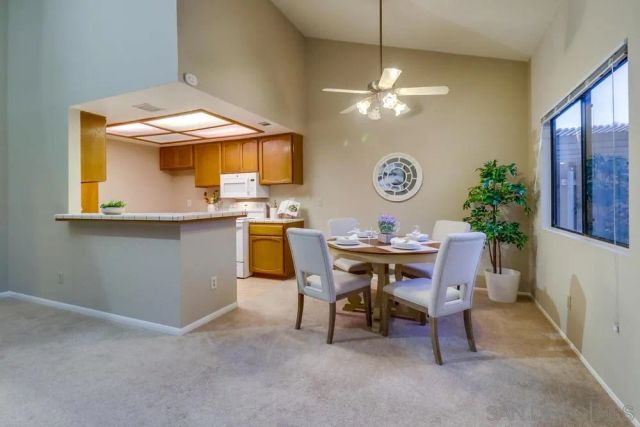 a view of a dining room with a table and chairs