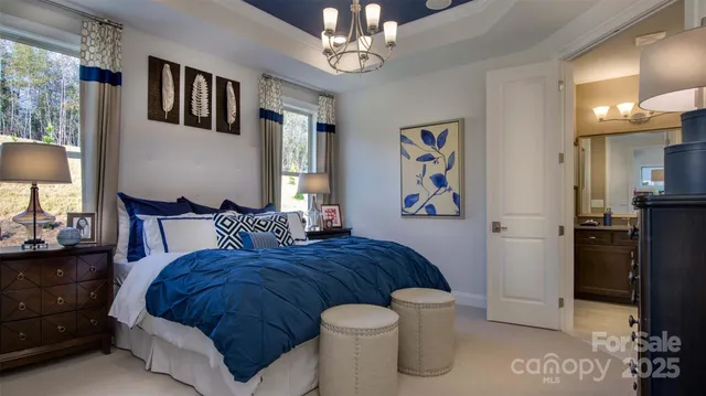 a spacious bedroom with a bed and a chandelier