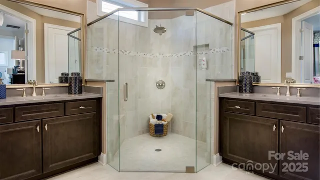 a bathroom with a sink vanity granite tub shower and a mirror