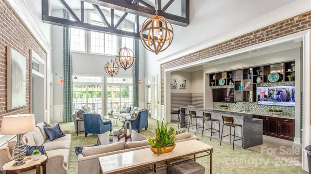 a living room with fireplace furniture and a large window
