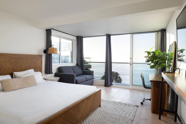 a bedroom with a large bed and a large window