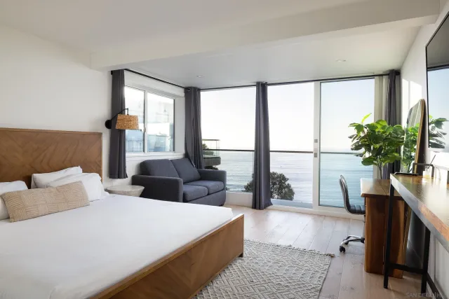 a bedroom with a large bed and a large window