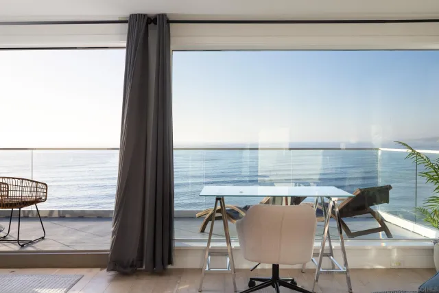 a view of a room with table and chairs