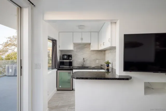 a kitchen with stainless steel appliances granite countertop a refrigerator and a stove