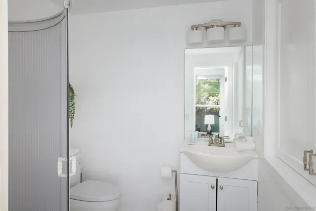 a bathroom with a sink a toilet and mirror