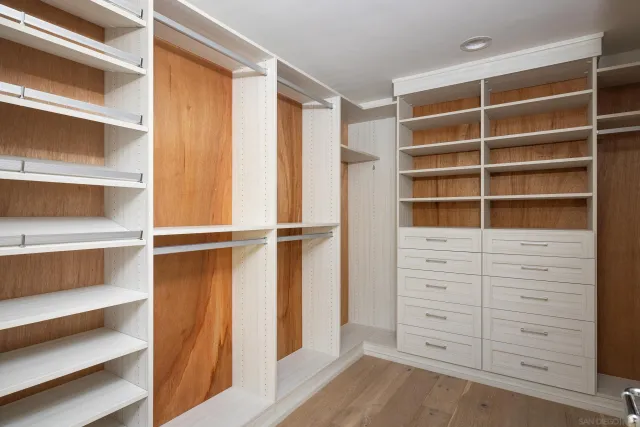 a view of walk in closet with empty racks