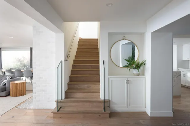 a view of entryway and hall with wooden floor