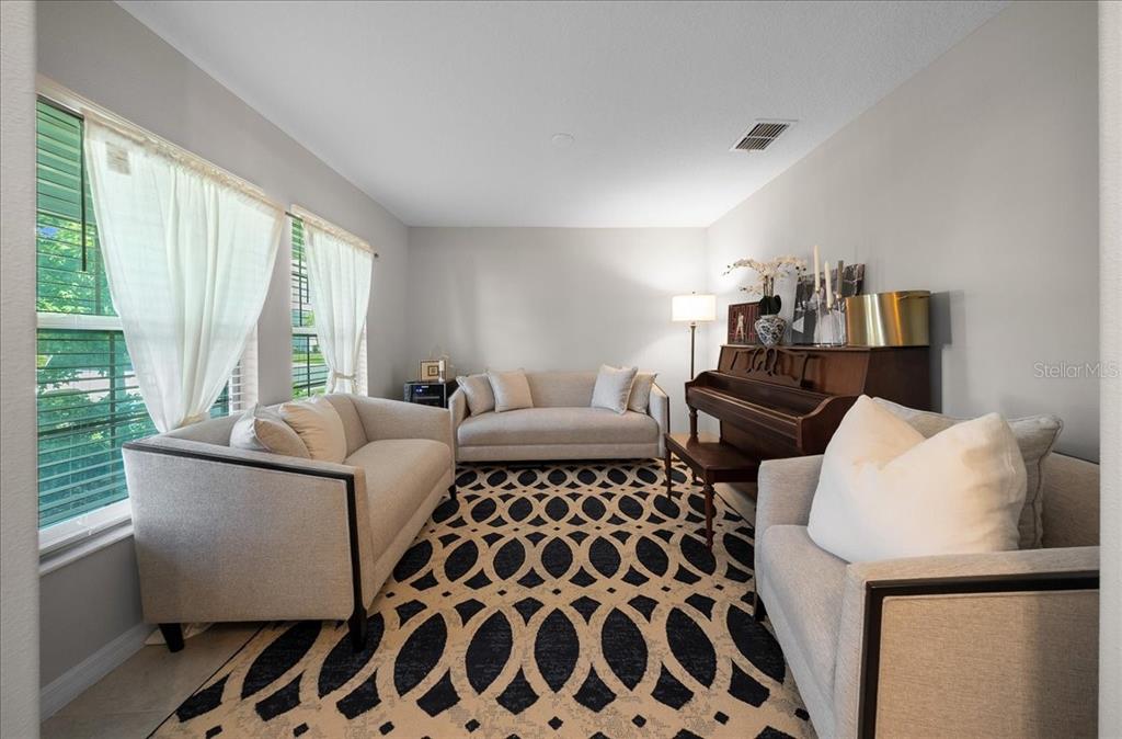 9329 Southwest 57th Terrace Ocala, FL 34476 - Photo 6 of 64 a living room with furniture lamp and window