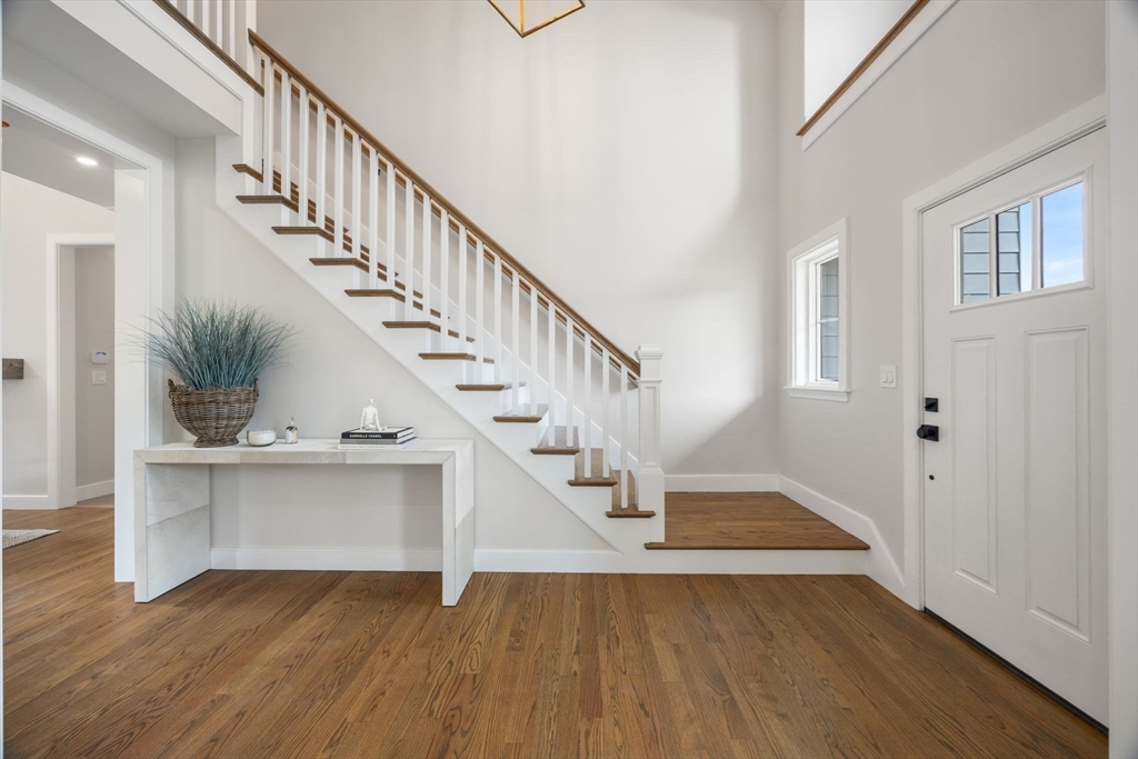 106 Horrigan Drive, Unit 21 Dedham, MA 02026 - Photo 21 of 32 a view of entryway and hall with wooden floor